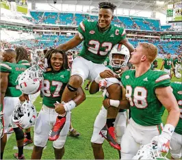  ?? AL DIAZ / MIAMI HERALD ?? Tight end Chris Herndon (above, getting carried off the field Nov. 18 after the Canes beat Virginia) injured the MCL in his left knee in Friday’s loss at Pitt.