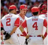  ?? JOHN MINCHILLO / ASSOCIATED PRESS ?? Reds starting pitcher Tyler Mahle (second from left) gets a visit on the mound after giving up a two-run double.