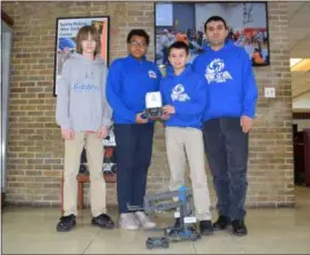  ?? BRIANA CONTRERAS — THE MORNING JOURNAL ?? Horizon Science Academy of Lorain eighth-graders Eddie Bowen, left, Jehiel Knight, Xzander Natal and Coach Semih Cetin pose with their trophy. The Cyclones took second place out of 40 other Ohio middle school teams at the Brookside Intermedia­te School’s Winter Tournament on Jan. 26.