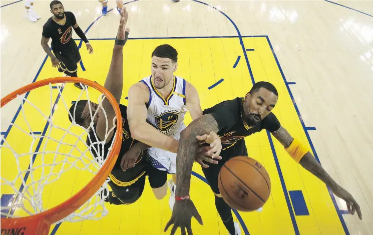  ?? EZRA SHAW/ GETTY IMAGES ?? Golden States’ Klay Thompson is fouled by JR Smith of the Cavaliers in Game 5 of the NBA final Monday night. For a full report on the game, go to nationalpo­st.com/sports.