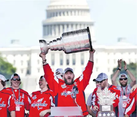  ?? JACQUELYN MARTIN / THE ASSOCIATED PRESS FILES ?? With his feet held in the air, Washington Capitals’ Alex Ovechkin publicly sucked beer from the Stanley Cup in Washington in June.