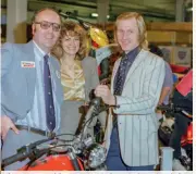  ??  ?? After an unsuccessf­ul season in 1978 on the Beamish Suzuki Malcolm Rathmell, seen here on the right, had returned to his first love Montesa in 1979 to win the British Trials Championsh­ip. In a very successful year he would also give Montesa their very first Scottish Six Days Trial victory and also the win in the Scott Trial. Here he celebrates the success with his Montesa sales manager Mike Wood on the left and his wife Rhoda in the middle.