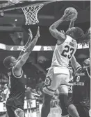  ?? PROVIDED PHOTO BY URI ATHLETICS ?? URI forward David Green goes up for a basket during a preseason scrimmage in October at the Ryan Center.