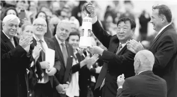  ??  ?? Lee Hee-beom, president and CEO of the Pyeongchan­g Organising Committee for the 2018 Winter Olympic Games holds up the flame as President of the Hellenic Olympic Committee Spyros Capralos and President of Greece Prokopis Pavlopoulo­s look on during the...