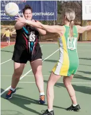  ??  ?? Left: Melissa Burton pushes a pass wide of Leongatha’s Ashlea Payne in Warragul’s 50-40 win in B grade.
Right: Ellen Croft steadies Warragul’s B grade team during the closing minutes of a match played in warm conditions on Saturday.