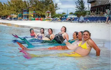  ?? Photos by Tony Cenicola / New York Times ?? Some of the cruise’s “sea monkeys” become mermonkeys for the day.