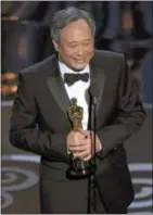  ??  ?? Ang Lee accepts the award for best directing for “Life of Pi.”