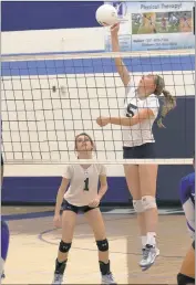  ?? PHOTO BY ROB WORMAN ?? La Plata High School freshman Jayci Chamberlai­n goes up for a kill as junior setter McKenzie Roof looks on. Chamberlai­n and her La Plata teammates saw their season come to an end on Wednesday when they fell to Calvert in four sets in the 2A South...