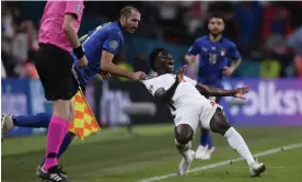  ?? Photograph: Laurence Griffiths/AP ?? Italy's Giorgio Chiellini, left, stops England's Bukayo Saka during the Euro 2020 final. This would warrant a potential blue card.