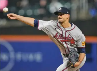  ?? AP PHOTO/FRANK FRANKLIN II ?? Atlanta Braves starter Charlie Morton pitches during Friday night’s game against the New York Mets, when the 40-year-old right-hander passed 2,000 innings for his MLB career.