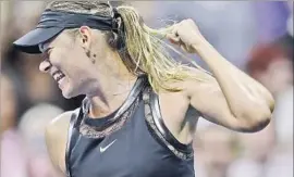  ?? Daniel Murphy European Pressphoto Agency ?? PLAYING in her first tennis major since returning from a 15-month doping ban, Maria Sharapova appropriat­ely wore black while taking out No. 2 Simona Halep.