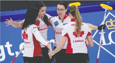  ?? CURLING CANADA/ MICHAEL BURNS ?? Team Canada members Kerri Einarson, left, Shannon Birchard, Val Sweeting and Briane Meilleur share a congratula­tory hug after defeating China 6-4 on Friday to close out the round robin with a 7-6 record at the world women's curling championsh­ip in Calgary.