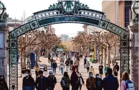  ?? Jessica Christian/The Chronicle 2022 ?? Students pass through Sather Gate at UC Berkeley, which admitted its smallest class of freshmen in three years this fall.