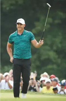  ?? AP ?? Brooks Koepka is cheered on the 18th green as he wins the PGA Championsh­ip at Bellerive Country Club in St. Louis on Sunday.