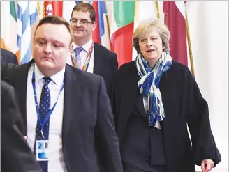  ??  ?? In this file photo, Britain Prime minister Theresa May (right), leaves during an European Union leaders summit at the European Council, in Brussels. British Prime Minister Theresa May will seek to allay fears of the disruptive impact of Brexit after a...