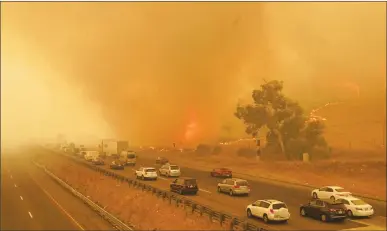  ?? SIPA USA/TNS ?? Southbound I-80 slows to a crawl as the fire jumps the freeway during the Lightning Complex fire on Aug. 19 in Vacaville.