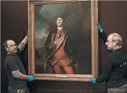  ?? KEVIN WOLF/AP ?? Dermot Rooney, left, and David Schlaegel prepare to put up the early George Washington portrait Thursday in Mount Vernon, Va. It’s on loan from Washington and Lee University.