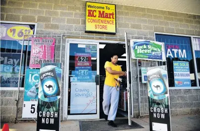  ?? PHOTO: REUTERS ?? Lucky spot . . . A woman leaves the KC Mart, in Simpsonvil­le, South Carolina, yesterday, where the winning Mega Millions ticket was sold.