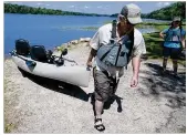  ?? BILL LACKEY / STAFF 2016 ?? Craig Mosley, with wife Madona alongside, pulled his kayak out of Kiser Lake last summer. A health advisory has been issued at the lake for this summer.