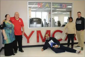  ?? MICHILEA PATTERSON — FOR DIGITAL FIRST MEDIA ?? From left to right, YMCA and Pottstown NAACP member Abby Weller-Hall, YMCA member Jim Frymoyer, Pottstown NAACP President Johnny Corson (laying on the floor), longtime Pottstown YMCA supporter and member Yvonne Jones and Pottstown YMCA Executive Director Scott Cusworth pose for a photo during the Pottstown YMCA grand re-opening and open house celebratio­n.