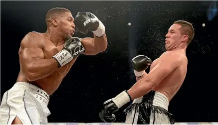  ?? GETTY IMAGES ?? Heavyweigh­t champion Anthony Joshua fails to tag Kiwi challenger Joseph Parker in their 2018 bout.