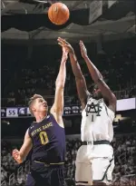  ?? AL GOLDIS — THE ASSOCIATED PRESS ?? Michigan State’s Joshua Langford, shooting over Notre Dame’s Rex Pflueger, scored 17points.