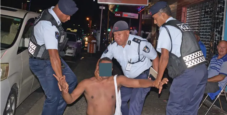  ?? Photo: Wati Talebula ?? Police officers holding down a man on New Year’s Eve in the capital city. Police were on patrol in the city centre to monitor people’s movement.