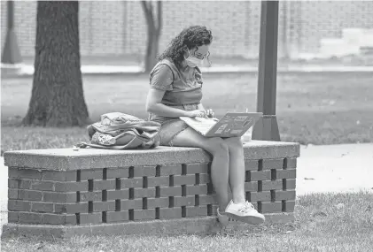  ??  ?? College students across the country need access to laptops to access online classes. At many community colleges, students are borrowing laptops to complete coursework. Access to Wi-Fi remains an issue. MICHAEL CONROY/AP