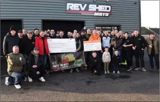  ?? ?? DONATION: Presenting two cheques, each for £1,300 to the Barnsley Hospice and Yorkshire Air Ambulance, staff and customers from Rev Shed Moto at Wombwell, who raised the money from their annual charity trial event in memory of Ben Carlile.