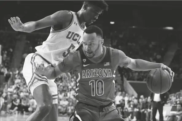  ?? ASSOCIATED PRESS ?? IN THIS FEB. 29, FILE PHOTO,
Arizona guard Jemarl Baker Jr. drives to the basket past UCLA guard Chris Smith during the first half of a game in Los Angeles.