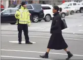  ?? Tyler Sizemore / Hearst Connecticu­t Media ?? A Greenwich Police officer directs traffic at Greenwich Avenue and Elm Street in 2020.