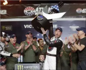  ?? JOHN BAZEMORE - THE ASSOCIATED PRESS ?? Kevin Harvick (4) hoists the trophy after wining the NASCAR Cup Series auto race at Atlanta Motor Speedway in Hampton, Ga., on Sunday.