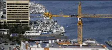  ?? TED S. WARREN — THE ASSOCIATED PRESS ?? A constructi­on crane works on a project in Seattle’s South Lake Union neighborho­od .