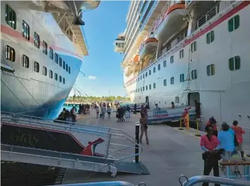  ?? CONTRIBUTE­D ?? Guests from both the Carnival Freedom and Mardi Gras cruise ships went ashore as scheduled on Grand Turk on Thursday despite a fire in Freedom’s funnel earlier in the morning.