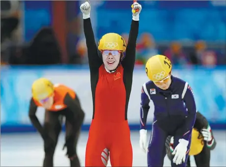  ?? ADRIAN DENNIS / AFP ?? Zhou Yang celebrates after winning the gold medal in the Women’s Short Track 1,500m Final at the Sochi Winter Olympics on Saturday.