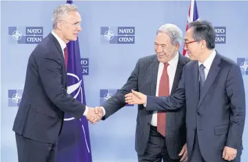  ?? AFP ?? Nato Secretary General Jens Stoltenber­g shakes hands with New Zealand’s Minister of Foreign Affairs Winston Peters, centre, and South Korean Foreign Minister Cho Tae-yul at the Nato Headquarte­rs in Brussels on Thursday.
