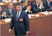  ?? ANDY WONG/AP ?? President Xi Jinping walks to his seat Sunday after casting his vote for an amendment to the Chinese Constituti­on.