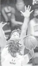  ?? DANIEL A VARELA/MIAMI HERALD VIA AP) ?? Miami guard Isaiah Wong (2) hangs in the air as he attempts to shoot the ball over Clemson’s Pj Hall (24) in the second half of an NCAA college basketball game in Coral Gables, Fla., on Saturday, Jan. 2, 2021.