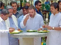  ?? AFP ?? Congress vice-president Rahul Gandhi (centre), Karnataka Chief Minister Siddaramai­ah (second left), state minister G. Parameshwa­ra (left) and senior Congress leader in-charge of Karnataka Venugopal (right) having lunch at the subsidised eatery Indira...
