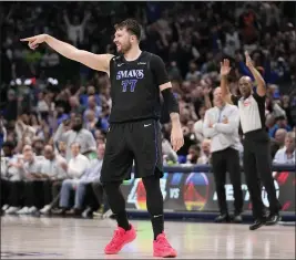  ?? TONY GUTIERREZ — THE ASSOCIATED PRESS ?? Mavericks guard Luka Doncic (77) celebrates after sinking a 3-point basket in the second half against the Suns in Dallas on Thursday.