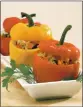  ?? PHOTO BY NICK KOON ?? Sweet-sour vegetarian stuffed bell peppers feature a mix of raisins, pine nuts, rice and seasonings.