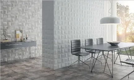  ??  ?? Bas-relief textured Keops tiles by Decus serve as wall decor in this dining area, the white wall forming a bright counterpoi­nt to the sand-coloured wall that better complement­s the floor tiles.