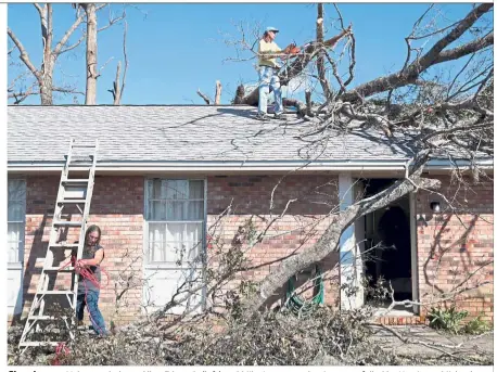  ??  ?? Cleaning up: Volunteer helpers Allen Edwards (left) and Mike Langston clearing trees felled by Hurricane Michael at a home in Springfiel­d, Florida. — Reuters