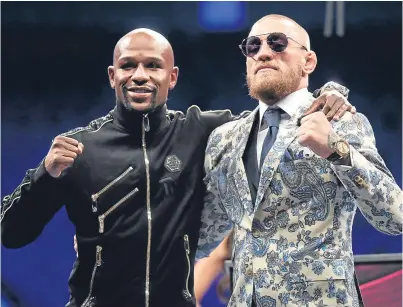  ?? Picture: AP. ?? Conor McGregor, right, with victor Floyd Mayweather Jr after the fight.