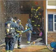  ?? SIDEWINDER PHOTOGRAPH­Y ?? Firefighte­rs from seven area companies battle a Sunday afternoon fire at Twin Lakes Apartments on Sitterly Road in Clifton Park.