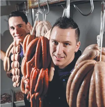  ?? Picture: STEWART McLEAN ?? EXPANSION PLANS: The Heights Boutique Butcher owner Nick Dagg (right) and butcher Breon Nolan with some of their award-winning sausages.