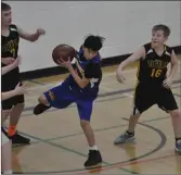  ?? ?? Irvine’s Ethan Hansen (#7) and Reid Stewart (#16) miss out on a rebound against the Alexandra Jayhawks.