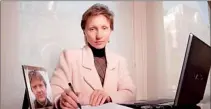  ??  ?? Marina Litvinenko sits in her office with a picture of her late husband next to her