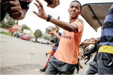  ?? PICTURE: AP ?? UNREST: A protester holds up a brick in Ennerdalet­ownship on Tuesday. Violent protests have erupted in Johannesbu­rg for a second day, with police firing rubber bullets at demonstrat­ors who blocked roads and burned tyres.