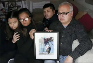  ?? JEFF CHIU — THE ASSOCIATED PRESS ?? Cassandra Quinto-Collins, second from left, holds a photo of her son, Angelo Quinto, while sitting with daughter Bella Collins, left, son Andrei Quinto, center, and husband Robert Collins during an interview in Antioch Tuesday, March 16, 2021. Angelo Quinto died three days after being restrained on Dec. 23, 2020, in police custody while having a mental health crisis. Lawmakers in several states are proposing legislatio­n that would require more training for police in how to interact with someone in a mental crisis following some high-profile deaths.